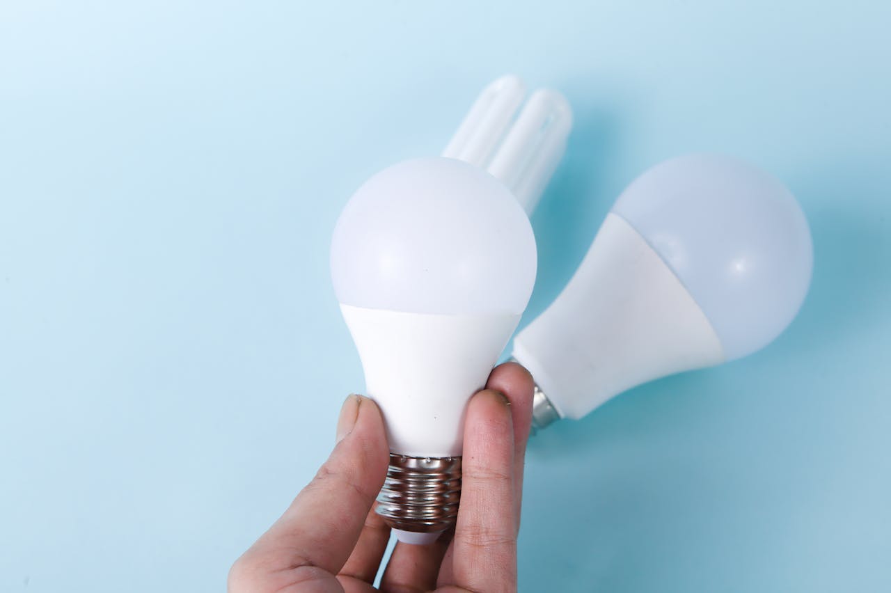services-06 Two LED light bulbs on a blue background, highlighting energy efficiency.