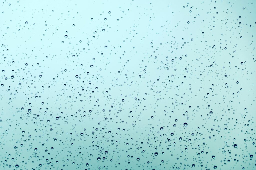 pexels-photo-2259232-2259232 A serene abstract view of water droplets scattered across a smooth glass surface, expressing tranquility.