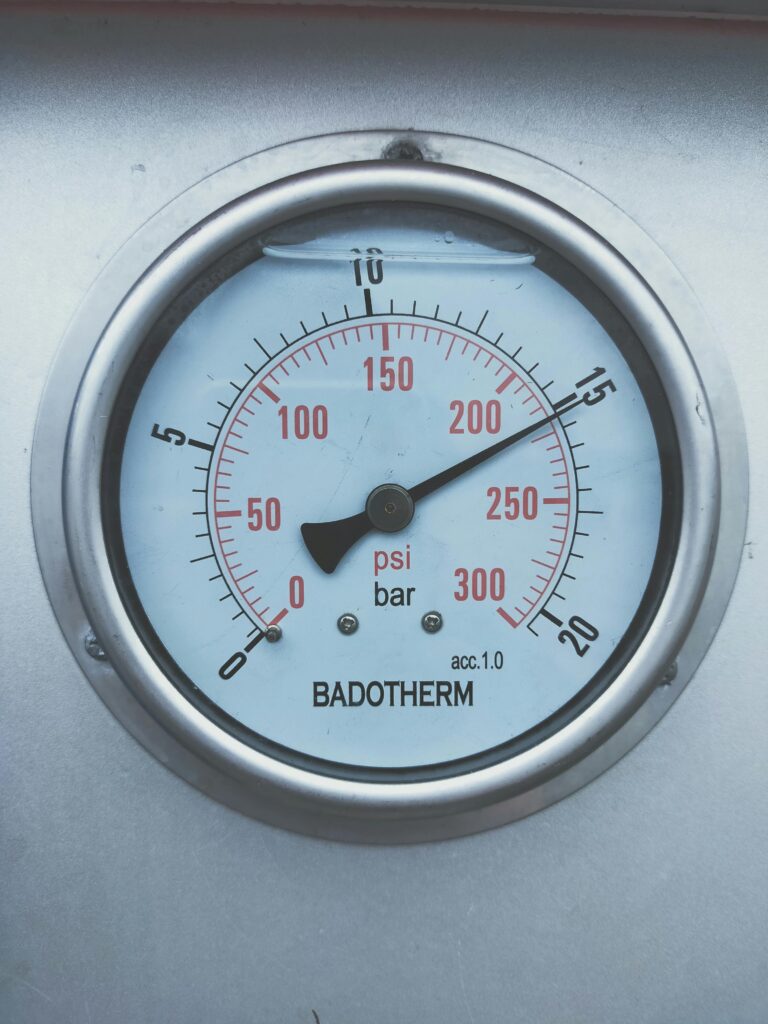 pexels-photo-5600225-5600225 Close-up of a Badotherm pressure gauge displaying measurements in PSI and bar.